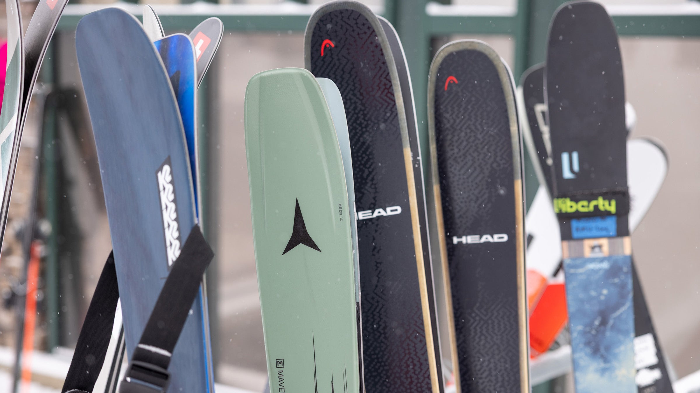All-mountain skis propped up on ski rack