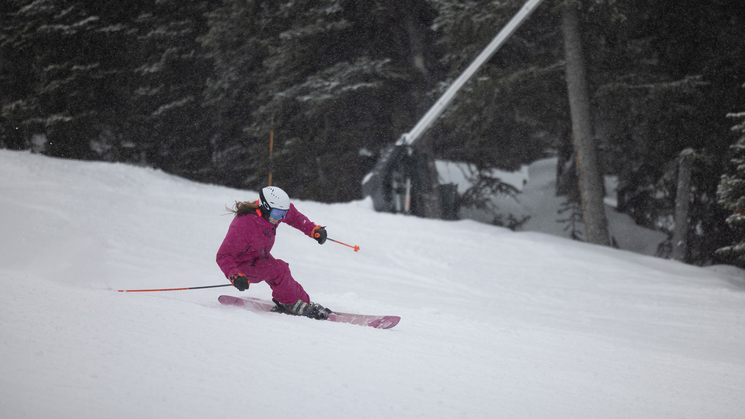 Skier in pink carving on groomed run