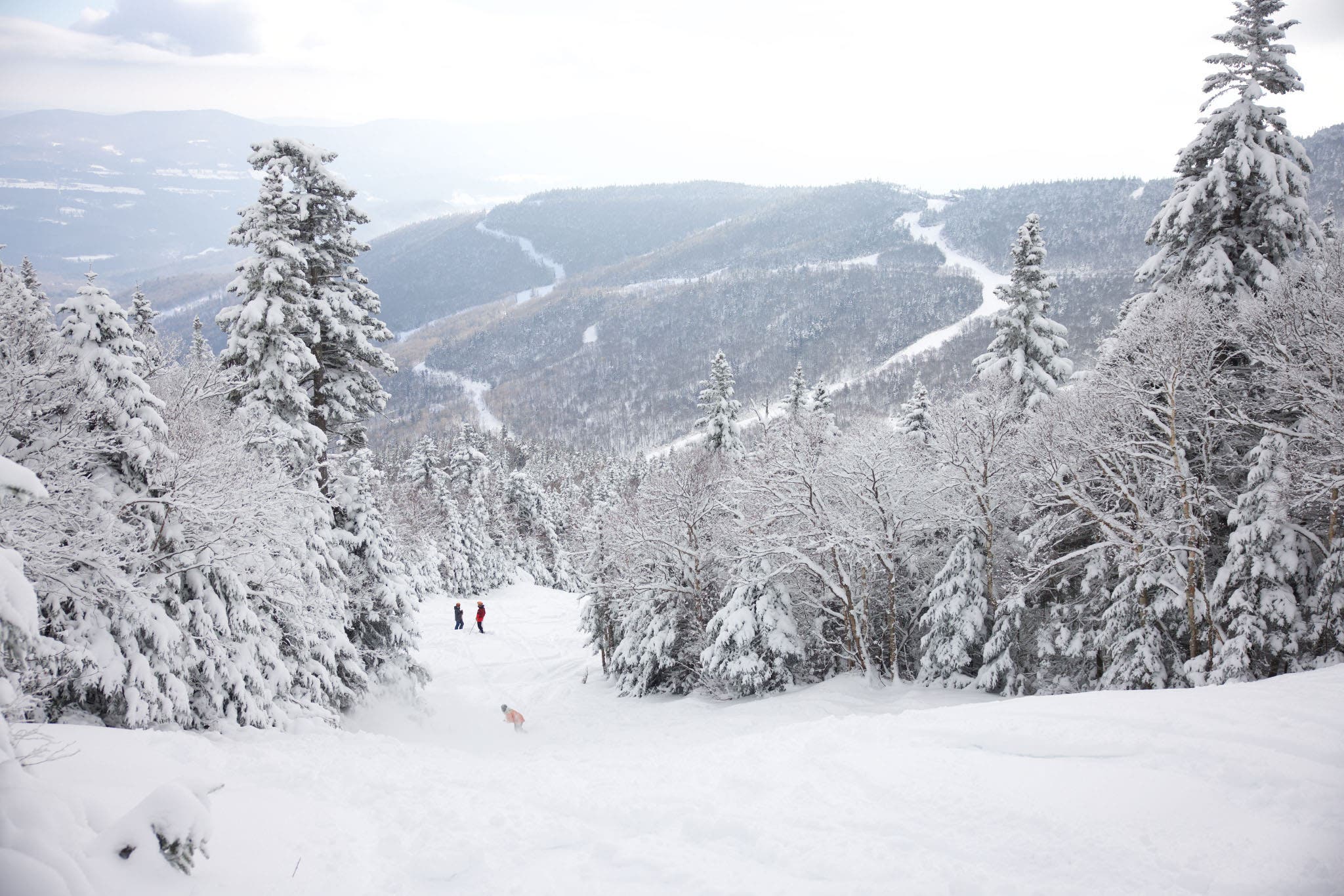 Pemain ski di salju berlari dengan sisa gunung menghadap