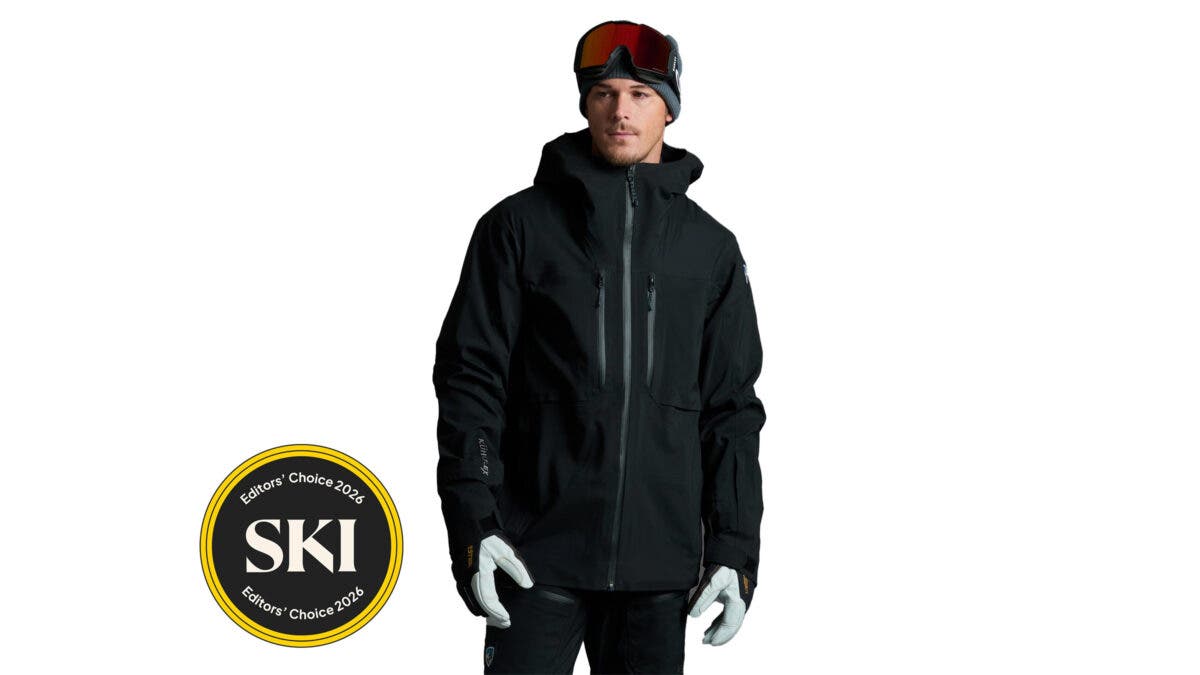 Man modeling black Kühl Defiant Ski Jacket on white background