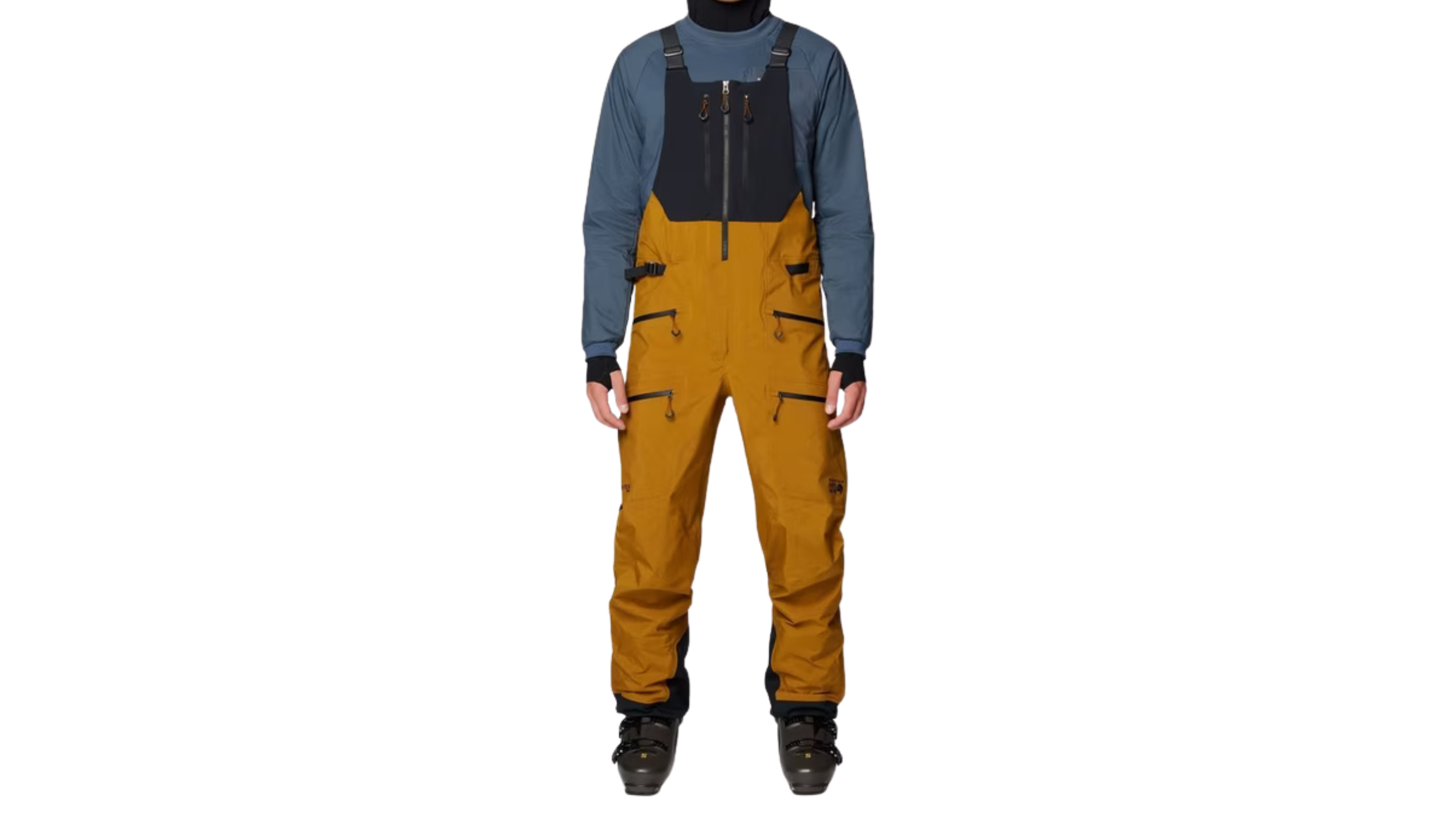 man standing in brown and black ski bib pants