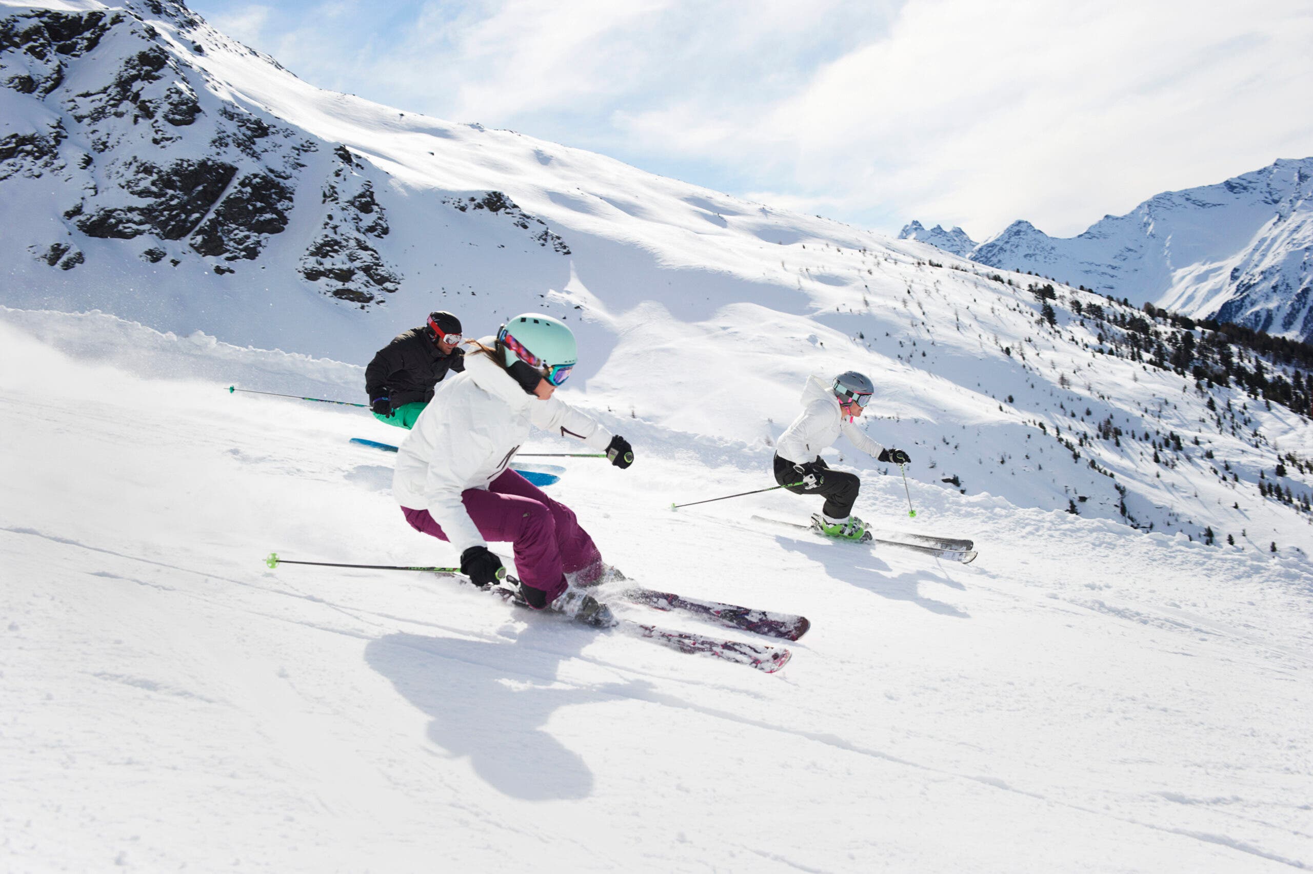 people skiing with helmets