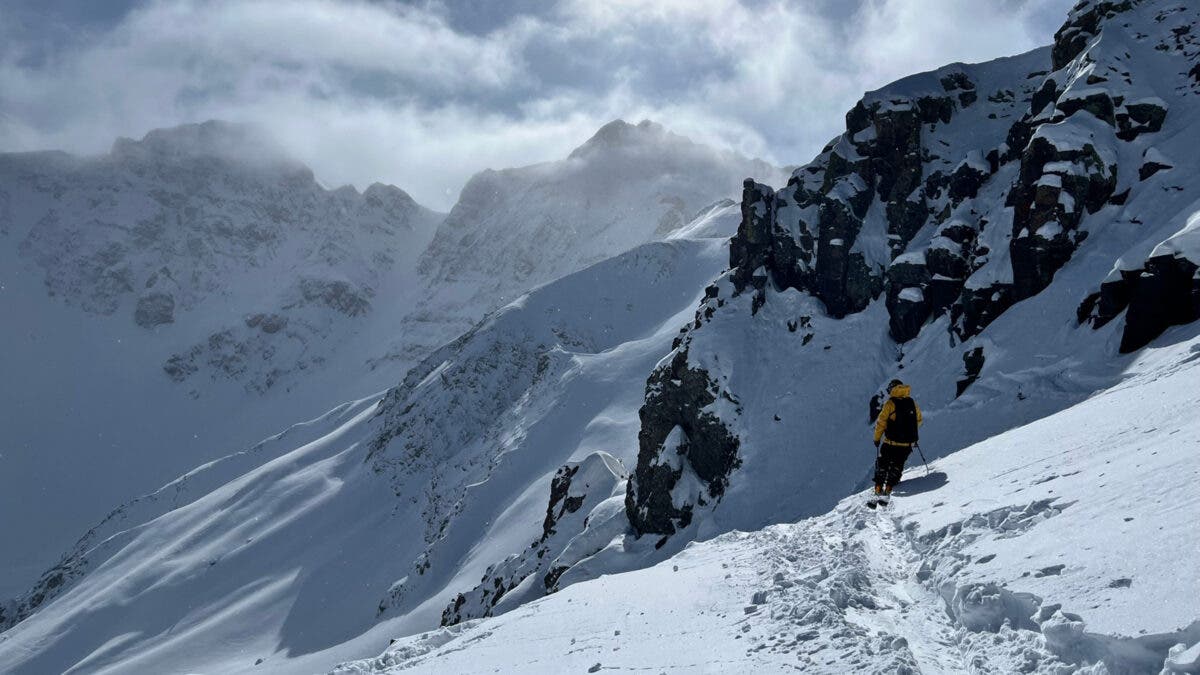 Skier at end of track in powder at Silverton Mountain testing Armada skis