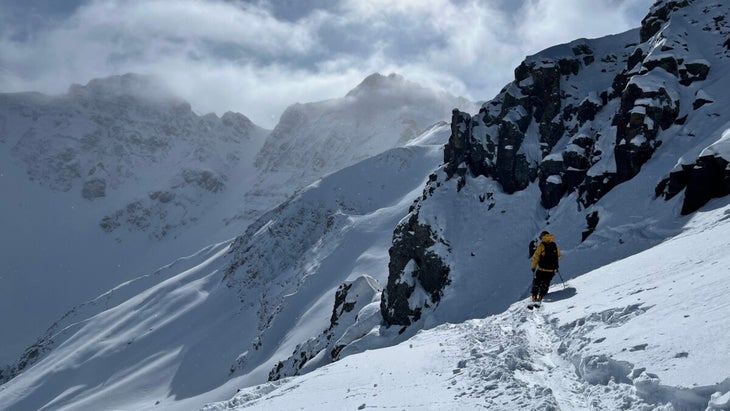 Skier at end of track in powder at Silverton Mountain testing Armada skis