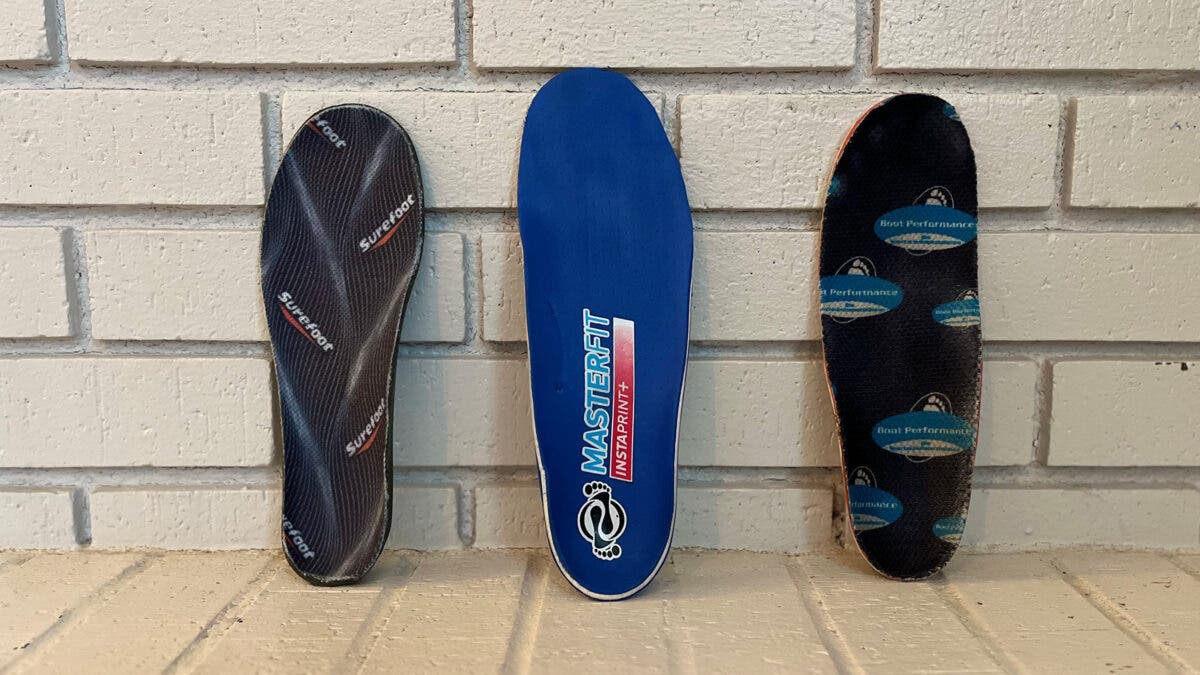 Three custom ski footbeds displayed on white brick background