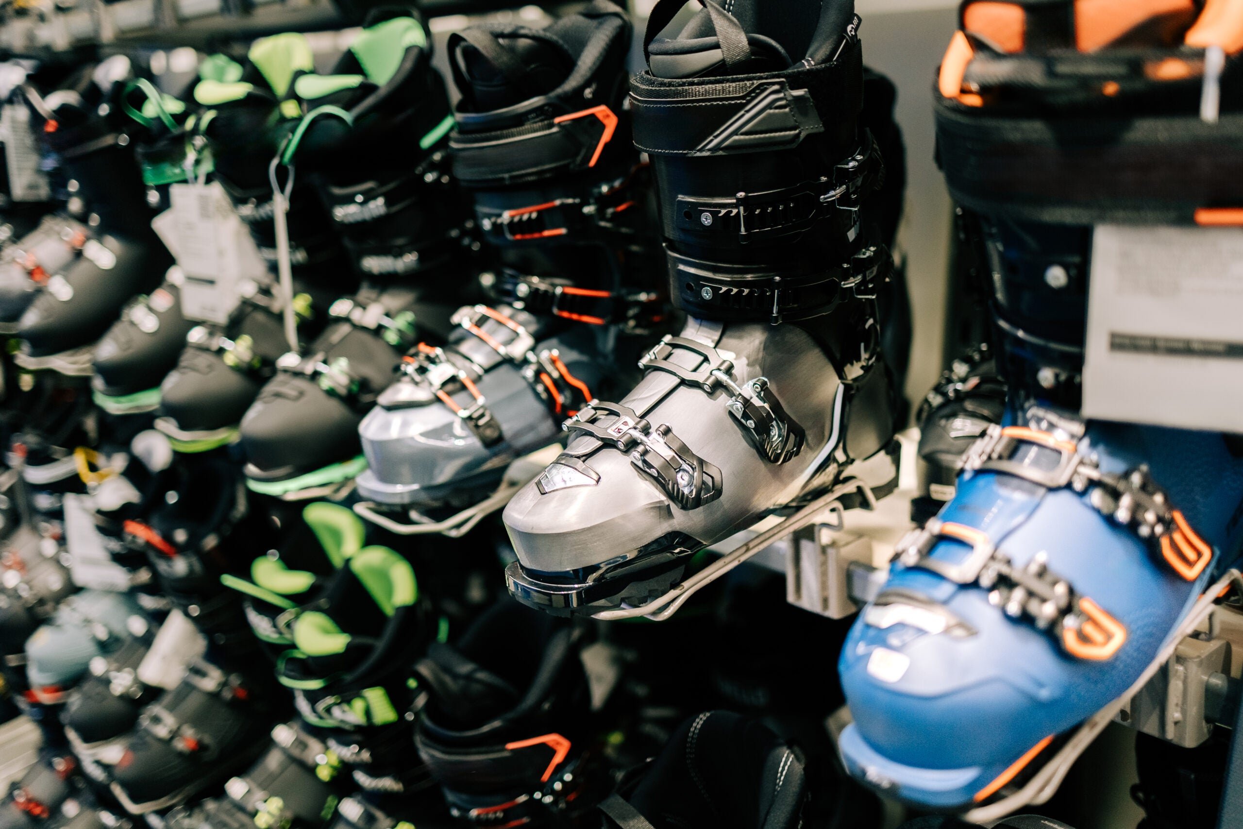Ski boots displayed on a rack in a sports shop