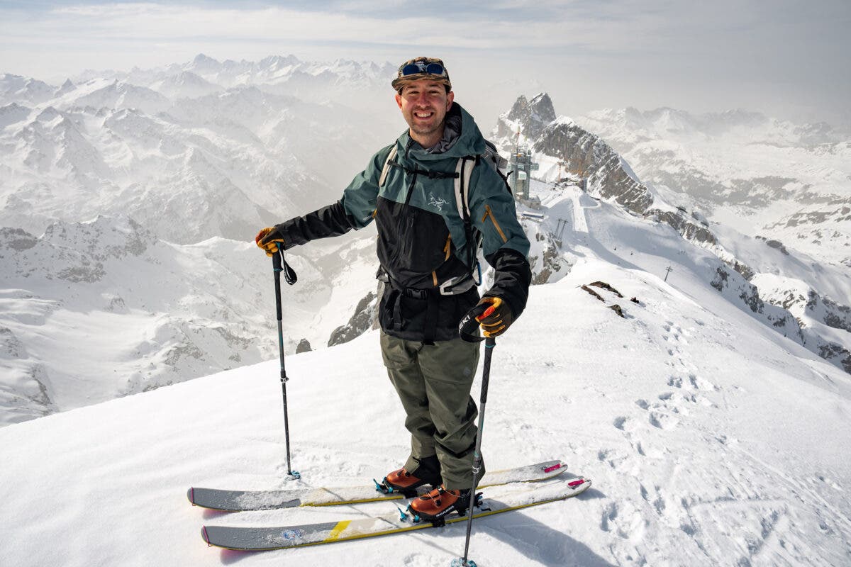 Man posing on top of snowy mountain on backcountry skis and wearing backcountry ski boots with BOA closure