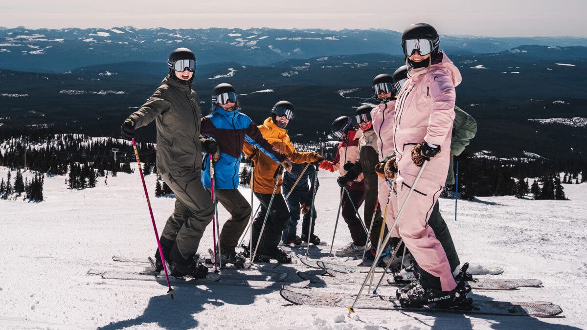Group of women skiers posing on ski slopes during Head women's summit at Big White ski area in Canada