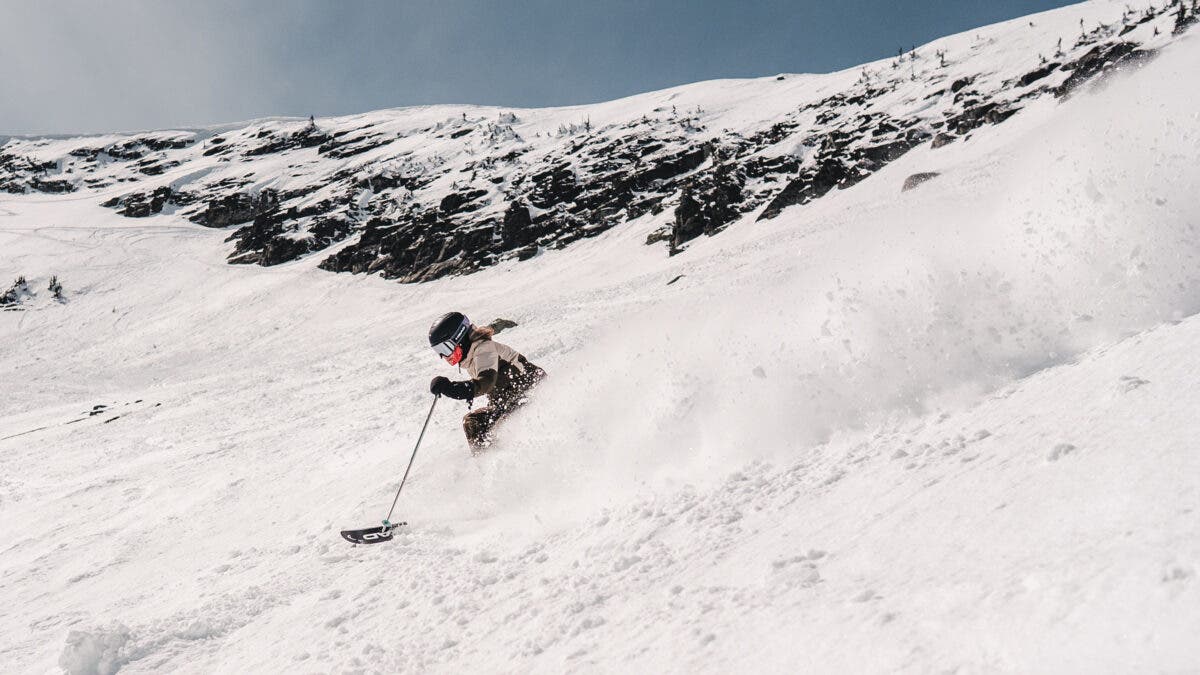 Female skier turning through chalky spring snow at Big White ski area