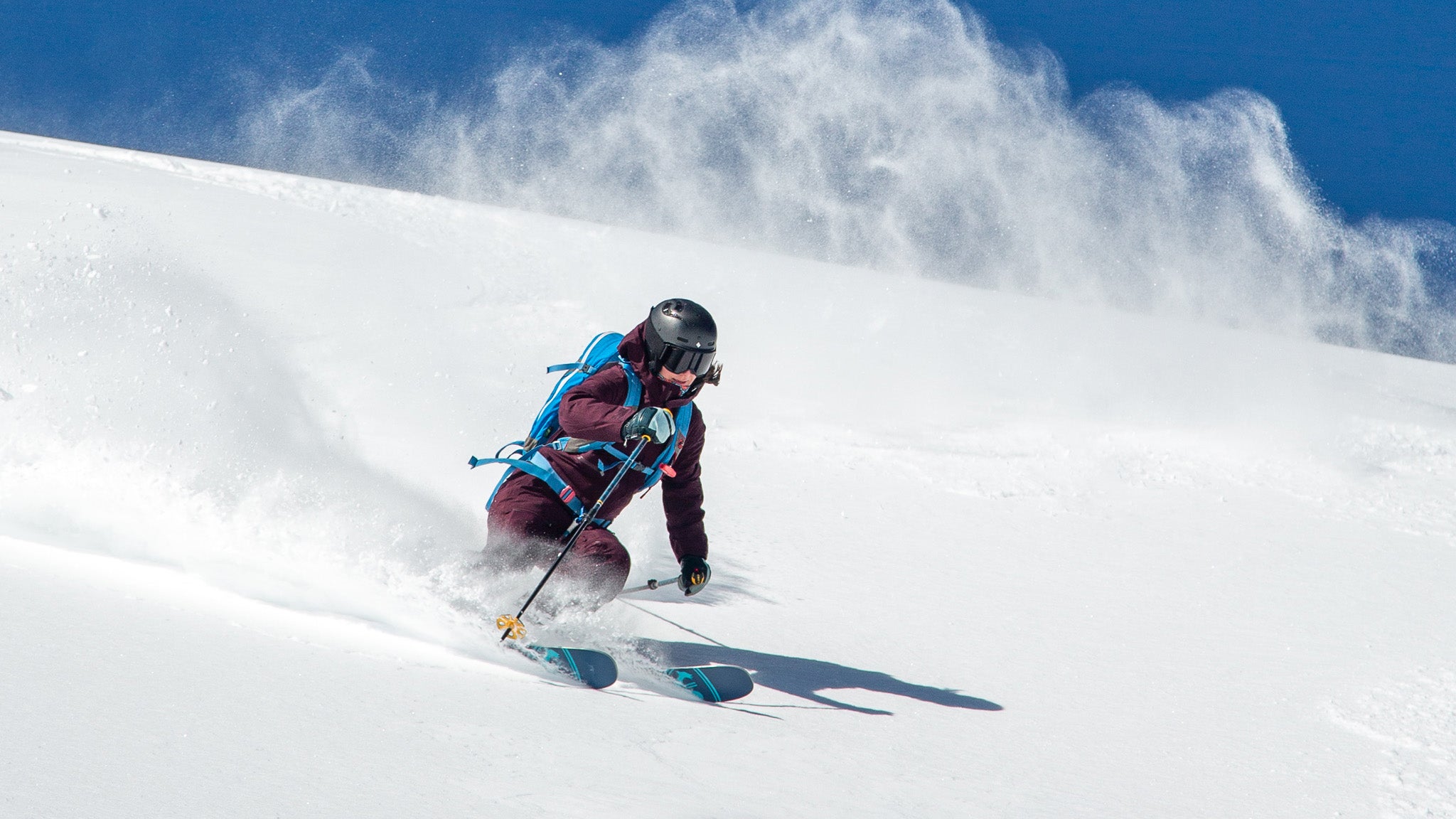 Jenny Wiegand skiing the Rossignol Rallybird 104 Ti through powder on bluebird day