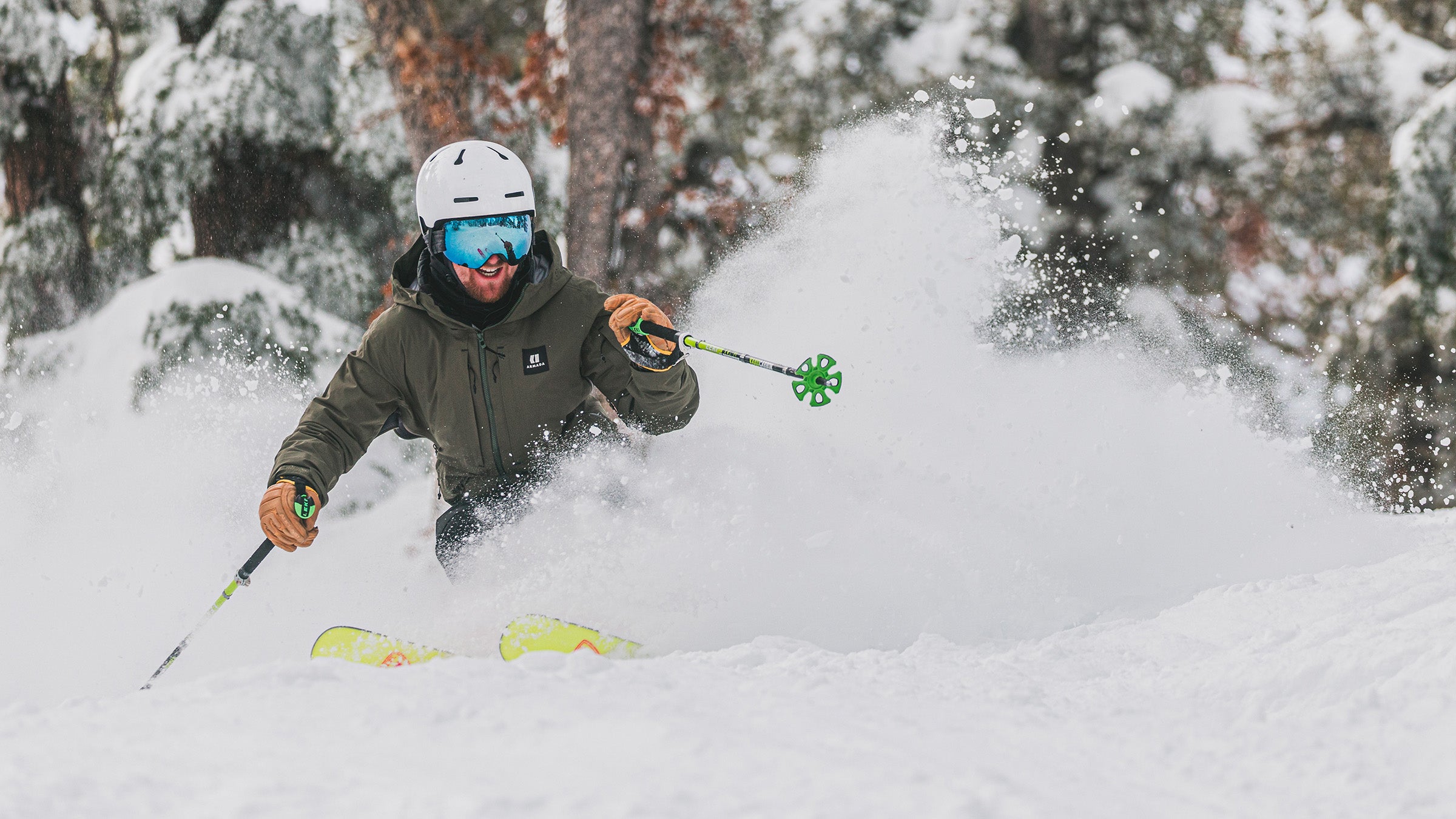 Skier getting to pole plant in powder while skiing Rossignol Super Black Ops through trees